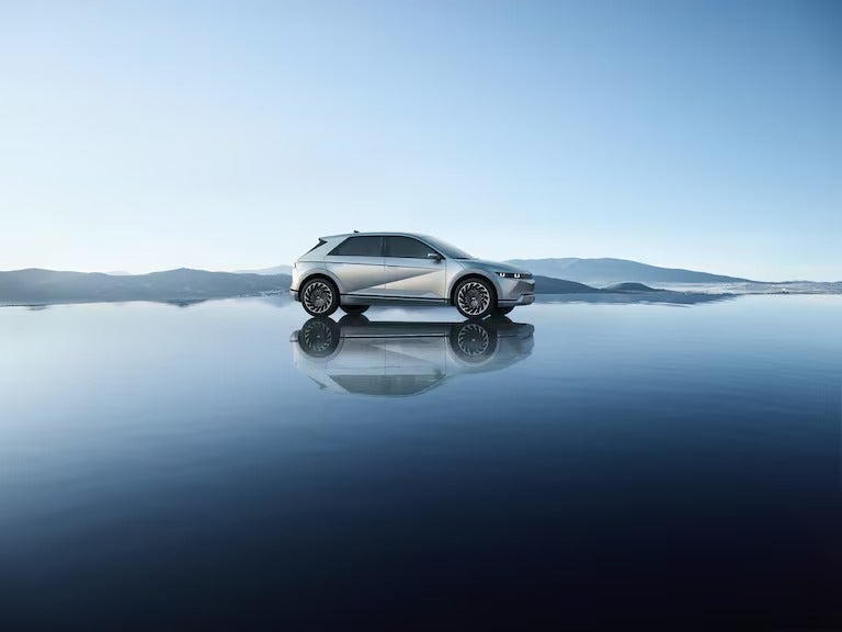 Hyundai Ioniq5 serenely sitting on top of highly reflective shallow water pool