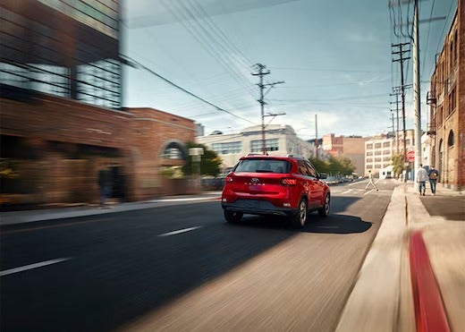 Rear view of Hyundai Venue driving down a road